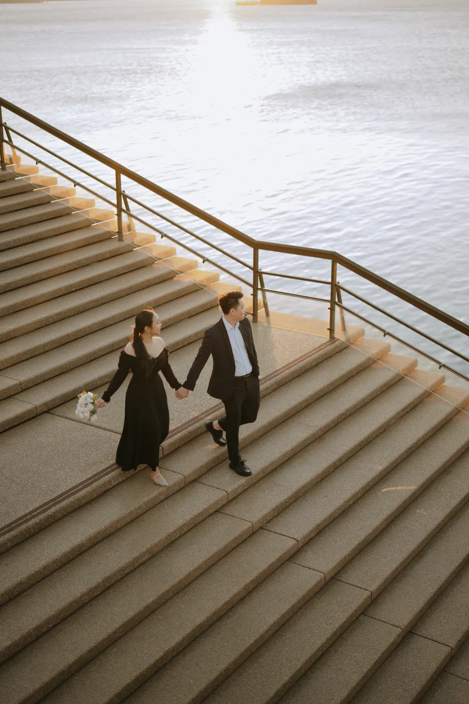 Handy Setiawan and Sharon Rebecca Joeniawan on the harbour steps, from their prewedding shoot